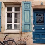 eine Hausfront mit alter blauer Tür und blauen Fensterläden in Erlangen